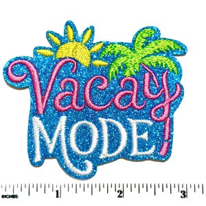 May include: A blue glittery embroidered patch featuring a yellow sun and a green palm tree. The text Vacay is in pink script and the word MODE is in white block letters. A ruler shows the patch is approximately 3.5 inches wide.