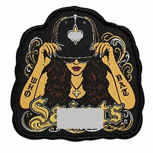 May include: A black embroidered patch featuring a person wearing a baseball cap with a fleur-de-lis emblem, sunglasses, and a necklace. The text "WHO DAT" is on the arms, and "Saints" is written in large gold lettering at the bottom.