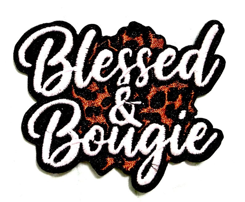May include: Embroidered patch with the words "Blessed & Bougie" in white script, outlined in black with a white border. The background features a leopard print pattern in shades of brown and black.