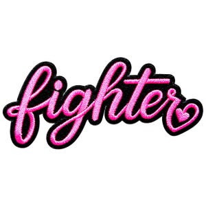 May include: An embroidered patch featuring the word fighter in a bright pink cursive script font with a thick black border. The letter r at the end of the word curves into a small pink heart shape, creating a cohesive and bold design element.