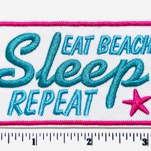 May include: Embroidered patch with a white background and a pink border. The patch features the words "Eat Beach Sleep Repeat" in turquoise script and block letters, with a pink star. The patch measures approximately 3 inches wide.