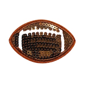 May include: A brown and gold sequined iron-on patch shaped like a football.