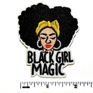 May include: Embroidered patch featuring a Black woman with a large afro, gold headband, and hoop earrings. The text "BLACK GIRL MAGIC" is displayed in bold, black letters on a white background. The patch is approximately 2 inches wide.