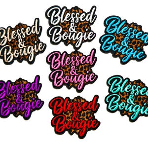 May include: Embroidered patches with the text "Blessed & Bougie" in various colors, including white, blue, purple, pink, red, and teal. The background of each patch features a leopard print design.