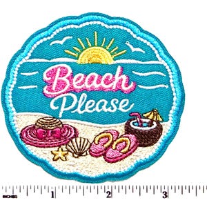 May include: A round embroidered patch with a scalloped edge featuring a beach scene with a yellow sun, a pink hat, a seashell, a starfish, pink flip-flops, and a coconut drink. The text reads Beach Please. A ruler shows it is 3 inches wide.