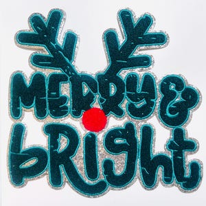 May include: A Christmas-themed decoration with the words "Merry & Bright" in teal, outlined with silver glitter. The design includes teal antlers and a red pom-pom nose, creating a festive holiday look.