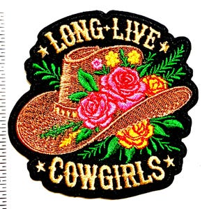 May include: Embroidered patch featuring a brown cowboy hat adorned with pink and yellow roses and green leaves. The patch has the text "LONG LIVE COWGIRLS" in gold lettering on a black background. The patch measures approximately 3 inches in height.