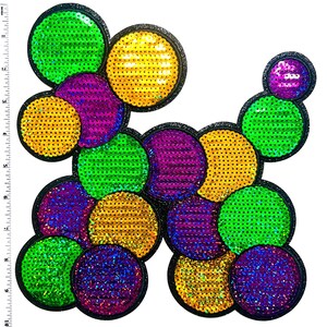 May include: A colorful sequin applique in a dog-like shape. The design features various sizes of circular sequins in green, yellow, purple, and blue, each outlined with black glitter. The sequins are arranged to resemble a playful dog.