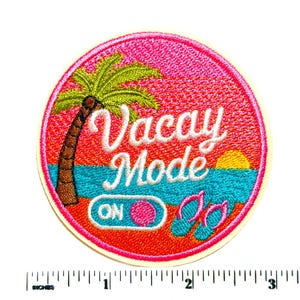May include: A circular embroidered patch featuring a tropical beach scene with a palm tree, a yellow sun, and blue water. The text reads Vacay Mode with an on-off switch graphic and pink flip-flops. A ruler shows the patch is 3 inches in diameter.