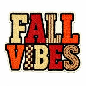 May include: An embroidered patch featuring the text FALL VIBES in a block font. The letters are colored in cream, red, and orange with black outlines. Some letters feature patterns including vertical stripes and a brown and cream checkerboard design.