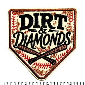 May include: Embroidered patch in the shape of a baseball home plate. The patch features the words "DIRT & DIAMONDS" in black script, with crossed baseball bats and red stitching accents. The border is brown.