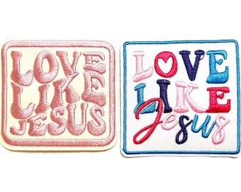 May include: Two embroidered patches with the phrase "LOVE LIKE JESUS". One patch is pink on a cream background, the other is multi-colored on white with a blue border. Religious themed.
