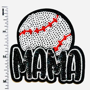 May include: A sequined patch featuring a baseball design with the word "MAMA". The baseball is white with a red seam, set against a black background. The word "MAMA" is in bold, black letters with a white outline.