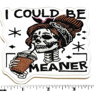 May include: Embroidered patch featuring a skull with brown hair, a pink bow, and a bandana, drinking from a coffee cup. The text "I COULD BE MEANER" is displayed in black. The patch has a white border.