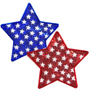 May include: Two star-shaped patches. One is blue with white stars, the other is red with white stars. Both patches are covered in sequins and have a white border. The patches are likely for patriotic or celebratory purposes.