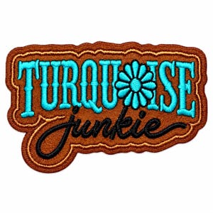 May include: A brown embroidered patch with a scalloped edge featuring the text TURQUOISE in bright blue block letters, a blue flower icon replacing the letter O, and the word junkie in black cursive script lettering below the main text.