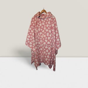 May include: Pink fleece hooded poncho with a white heart pattern.