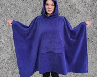 May include: A royal blue hooded fleece poncho with a kangaroo pocket. The poncho is made of soft, warm fleece and is ideal for keeping warm on chilly days.
