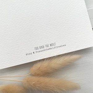 May include: White card with the text "Fox and the Wolf" and "Etsy FoxandtheWolfCreates" printed on it.