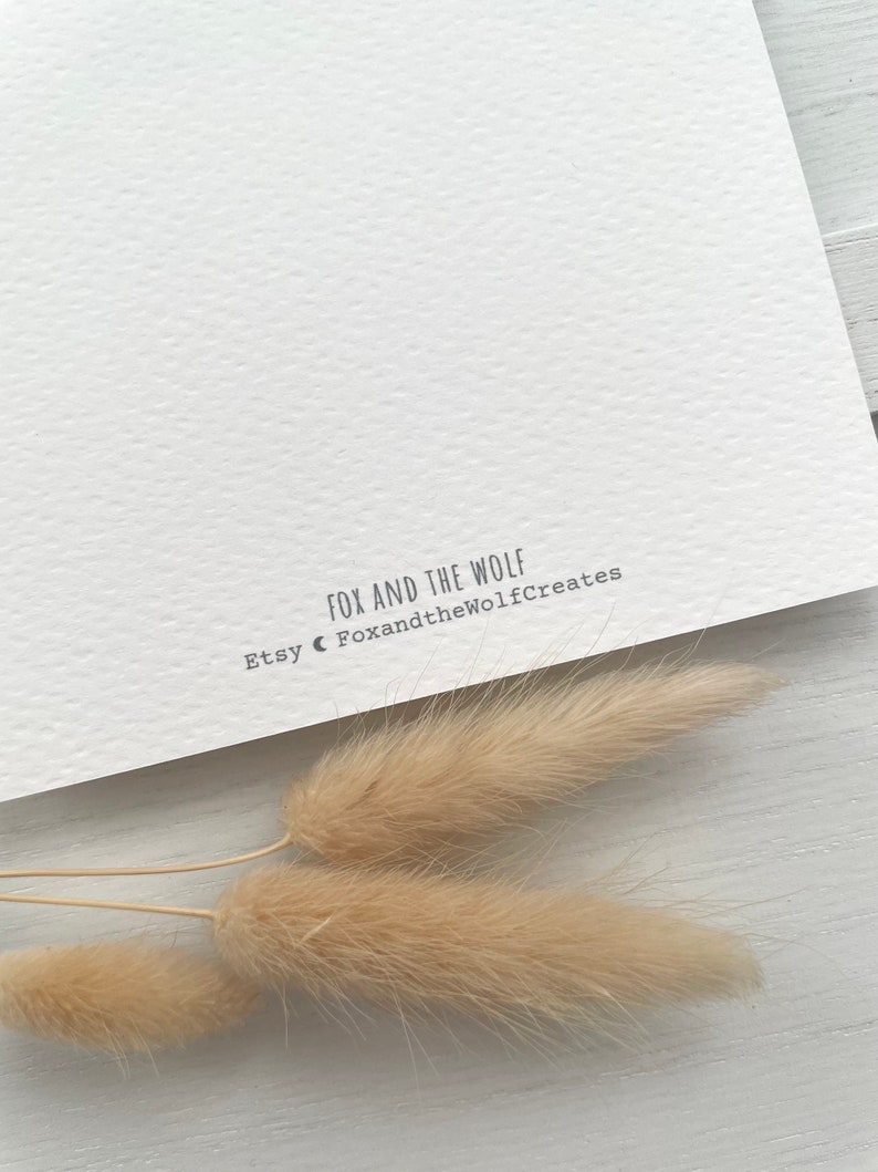 May include: White card with the text "Fox and the Wolf" and "Etsy FoxandtheWolfCreates" printed on it.