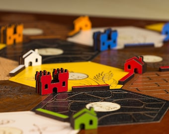 Elementy gry Settlers i organizer/uchwyt