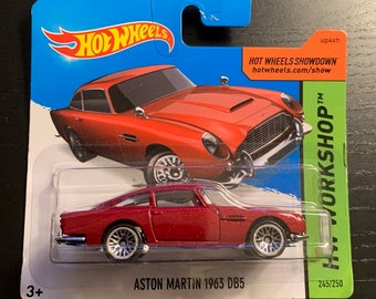 May include: A red Hot Wheels Aston Martin 1963 DB5 die-cast car on a blue and green card. The card features the Hot Wheels logo and the text "HOT WHEELS SHOWDOWN". The car is 245 of 250 in the series.
