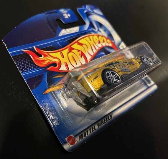 Hot Wheels Super Tsunami- Like Toyota Supra-gold With Blue Windows