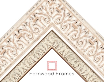May include: Two ornate picture frames with a white and gold finish. The frames have a decorative, raised design. The text "Fernwood Frames" is at the bottom of the image.