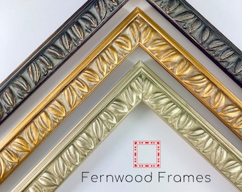 May include: Three picture frames with ornate leaf designs. The frames are in shades of gold, silver, and brown. The frames are arranged in a triangular shape with the Fernwood Frames logo in the center.