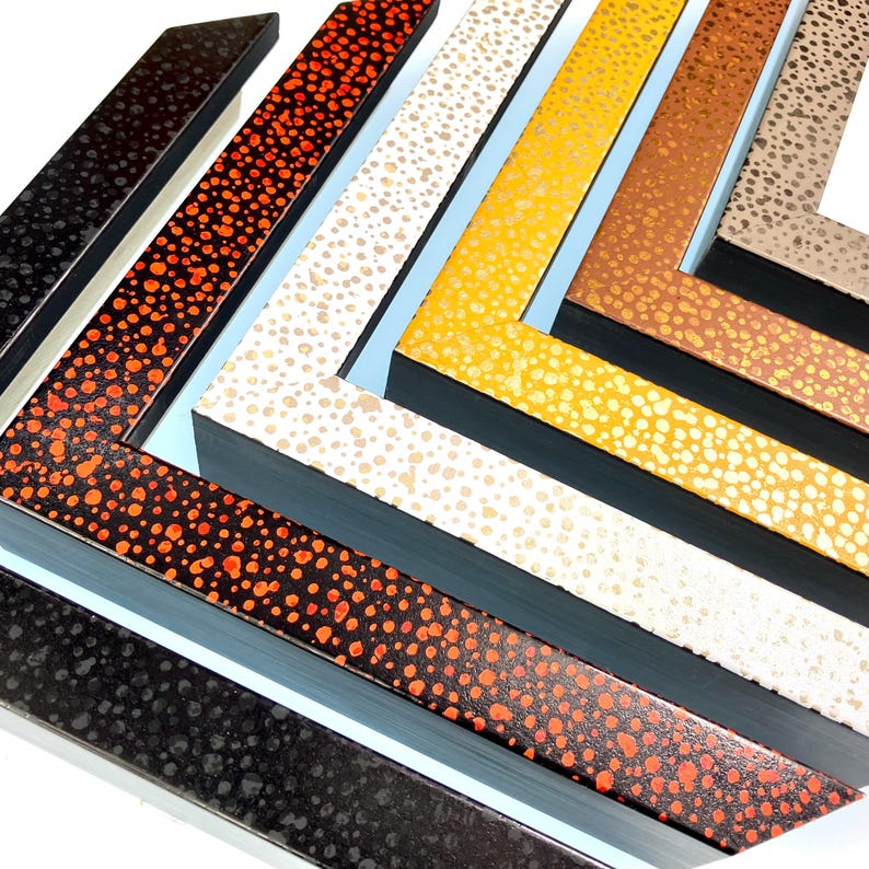 May include: Five picture frames with different colored speckled paint finishes. The frames are arranged in a stack, with the black frame at the bottom and the beige frame at the top.