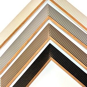 May include: Five picture frames with different colored wood and a ribbed design. The frames are arranged in a pyramid shape with the largest frame at the bottom and the smallest frame at the top.