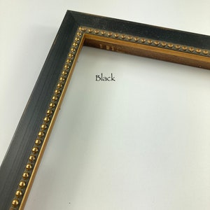 May include: Black picture frame with a gold beaded trim. The frame is made of wood and has a distressed finish.