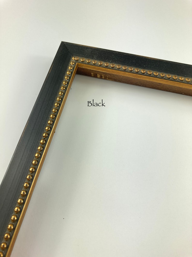 May include: Black picture frame with a gold beaded trim. The frame is made of wood and has a distressed finish.
