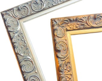 May include: Two ornate picture frames, one silver and one gold, with intricate floral designs. The frames are positioned to overlap, creating a layered effect.
