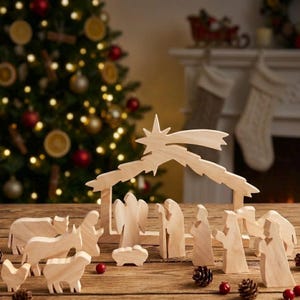 May include: A light-coloured wooden nativity set featuring carved figures of an angel, figures in robes, a manger, and various animals. The set includes a stable structure topped with a large star, all arranged on a flat surface with small pinecones.