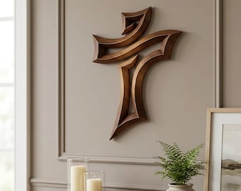 May include: A wall-mounted cross sculpture crafted from dark brown wood with a smooth, polished finish. The cross features a stylized, angular design with sharp, pointed edges and a hollow center, creating a layered, three-dimensional appearance.