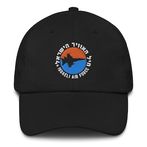 Puede incluir: Gorra de béisbol negra con un parche bordado que presenta un avión a reacción, las palabras "Israeli Air Force" y texto en hebreo.