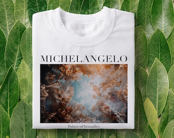 May include: White t-shirt with a print of a painting by Michelangelo. The painting is of a ceiling with clouds and figures. The text "Michelangelo" is printed above the painting and "Palace of Versailles" is printed below.