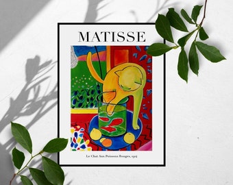 May include: A colorful painting by Henri Matisse titled "Le Chat Aux Poissons Rouges" (The Cat with the Red Fish) depicting a yellow cat reaching into a glass bowl with red fish. The painting is set against a background of a window with a green landscape and a red wall.