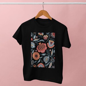 May include: Black t-shirt with a floral print design featuring a variety of colors including red, orange, yellow, blue, and green.