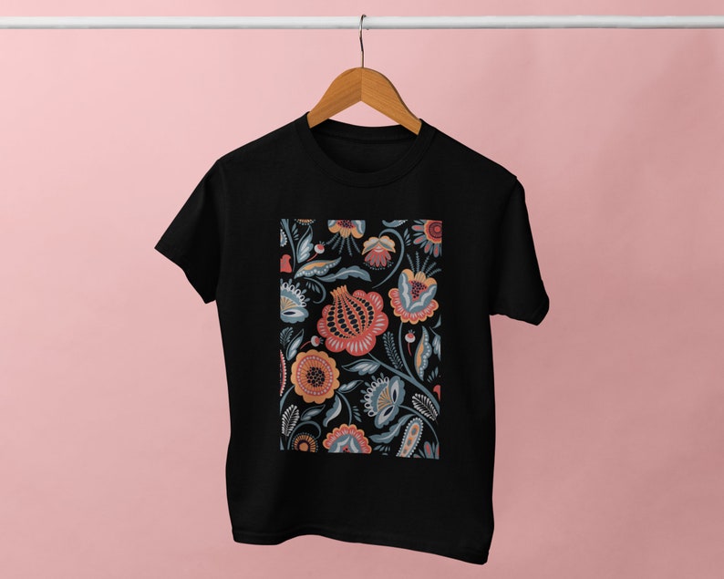 May include: Black t-shirt with a floral print design featuring a variety of colors including red, orange, yellow, blue, and green.