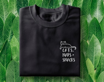 May include: Black t-shirt with a white outline of a cat and the text "CATS. NAPS + SNACKS" on the front.
