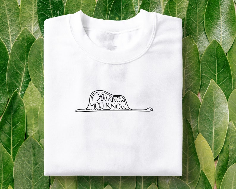 May include: White t-shirt with a black line drawing of a worm with the text "If you know, you know" on it.