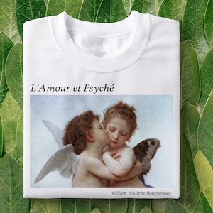 Pode incluir: Uma camiseta branca com uma estampa de uma pintura que retrata dois anjos se abraçando. A pintura é intitulada "L'Amour et Psyché" e é atribuída a William-Adolphe Bouguereau.