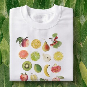 100% Cotton Unisex T-shirt in White, with print of mixed fruit: apple, orange, pear, cherries, pineapple, figs, citrus, kiwi, strawberry, pomegranate, lemon, lime, dragonfruit, grapes, peach, banana