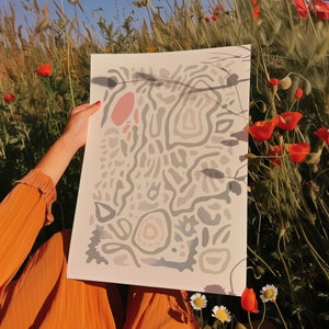 May include: A white sheet of paper with a hand-drawn abstract design in shades of grey, blue, and pink. The design features organic shapes and lines, creating a flowing and abstract pattern.