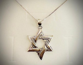 May include: A silver Star of David pendant necklace with a detailed woven design.