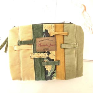 Close-up of denim texture, belt loop detail and floral strip. Shows repurposed materials thoughtfully arranged into one unique padded pouch.