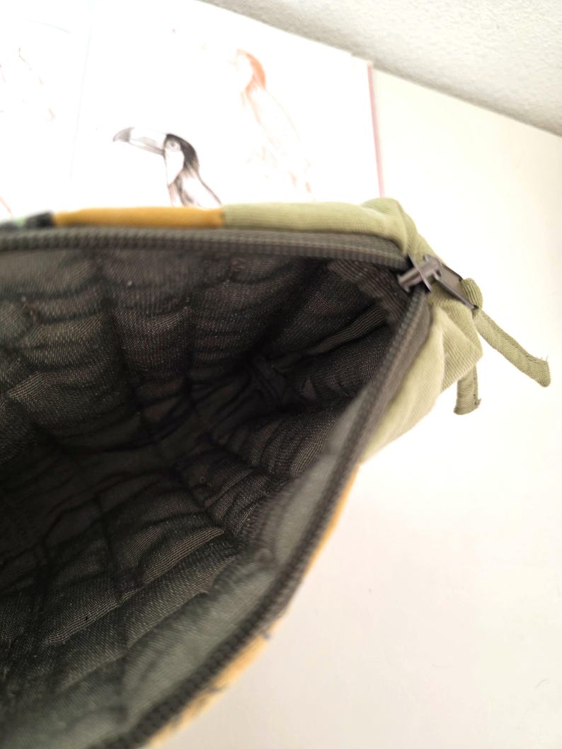 Detail shot of smooth zipper and precise stitching on the upcycled denim pouch. Highlights quality construction, softness and longevity of the design.
