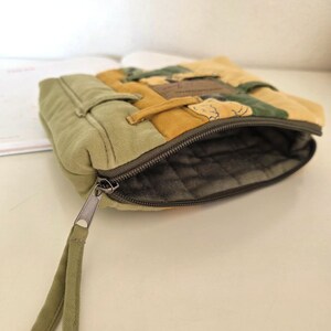 Inside view of light-green water-repellent lining, open zipper visible. Practical interior keeps cosmetics protected, easy to clean and comfortable for daily use.
